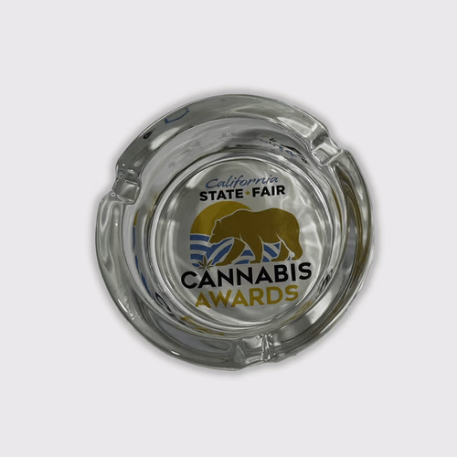 A LuminAsh glow in the dark custom glass ashtray with a logo